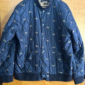 The North Face Black Quilted Jacket with Gold Accent Print